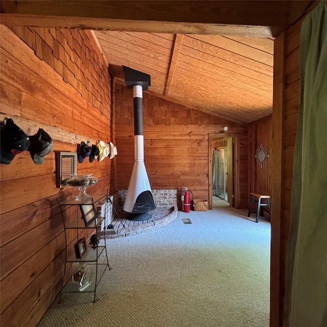 11 Sherry Ln, Coldspring, TX 77331 - living room with vaulted ceiling, wood walls, carpet floors, and a wood stove