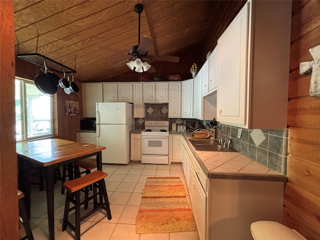 11 Sherry Ln, Coldspring, TX 77331 - kitchen featuring white appliances, tile countertops, a sink, light tile patterned floors, and backsplash