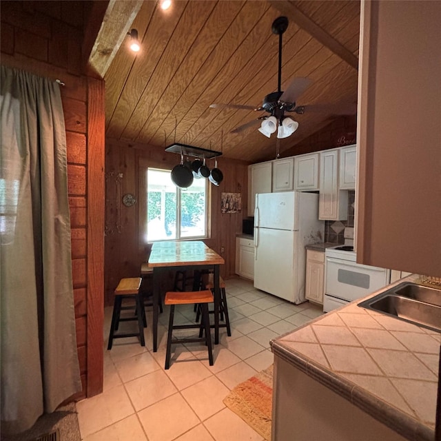 11 Sherry Ln, Coldspring, TX 77331 - kitchen with white appliances, tile countertops, white cabinetry, a ceiling fan, and wood ceiling