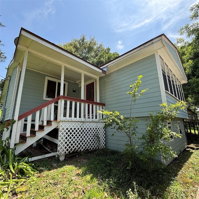 11 Sherry Ln, Coldspring, TX 77331 - view of front facade featuring covered porch and stairs