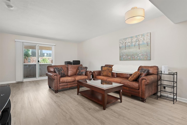 215 Post Office St Unit 1208, Galveston, TX 77550 - living room featuring light wood finished floors and baseboards