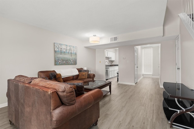 215 Post Office St Unit 1208, Galveston, TX 77550 - living area featuring light wood-style flooring and baseboards