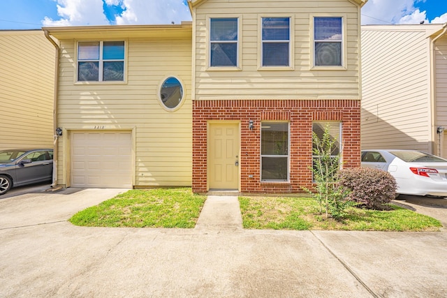 2212 Naomi St, Houston, TX 77054 - multi unit property featuring a garage, concrete driveway, and brick siding