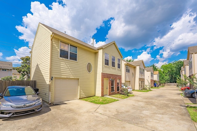 2212 Naomi St, Houston, TX 77054 - view of front of home with concrete driveway, brick siding, an attached garage, and a residential view