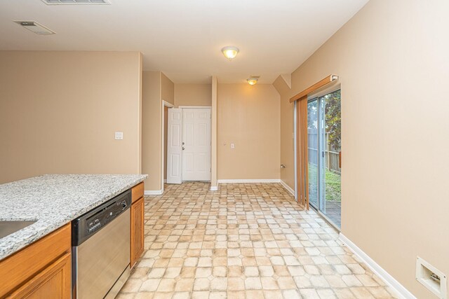 2212 Naomi St, Houston, TX 77054 - kitchen featuring stainless steel dishwasher, stone finish flooring, brown cabinetry, and light stone counters