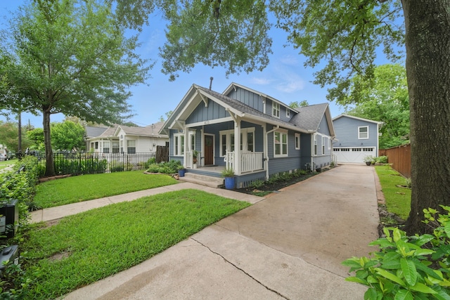 423 Pecore St, Houston, TX 77009 - bungalow-style house with board and batten siding, a porch, driveway, and an attached garage