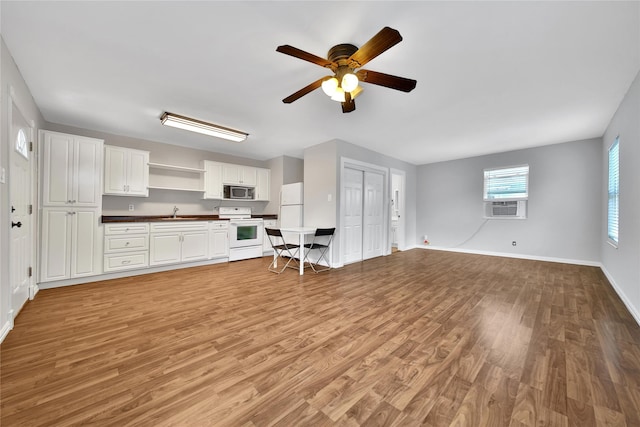 423 Pecore St, Houston, TX 77009 - kitchen featuring white appliances, light wood-style floors, open floor plan, and a ceiling fan