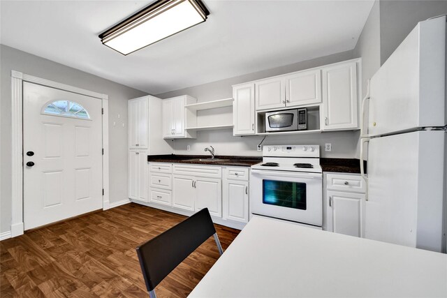423 Pecore St, Houston, TX 77009 - kitchen with white appliances, open shelves, white cabinets, and dark wood finished floors