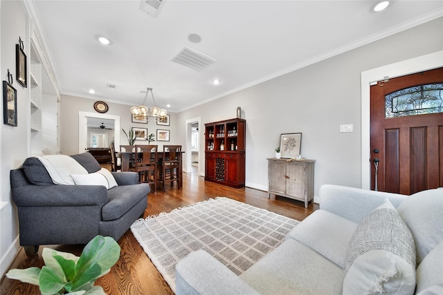 423 Pecore St, Houston, TX 77009 - living area featuring a chandelier, recessed lighting, crown molding, and wood finished floors