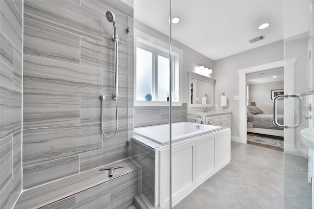423 Pecore St, Houston, TX 77009 - ensuite bathroom with a tile shower, vanity, recessed lighting, and tile patterned flooring