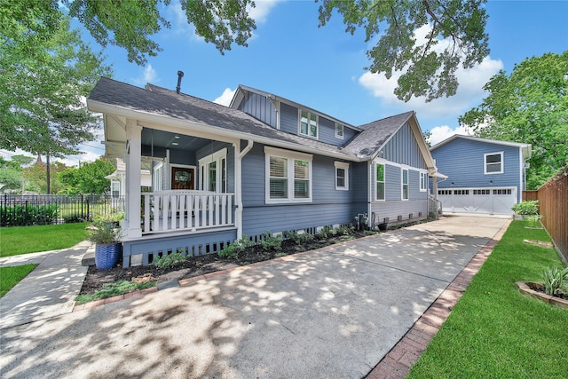 423 Pecore St, Houston, TX 77009 - bungalow featuring covered porch, roof with shingles, concrete driveway, and board and batten siding