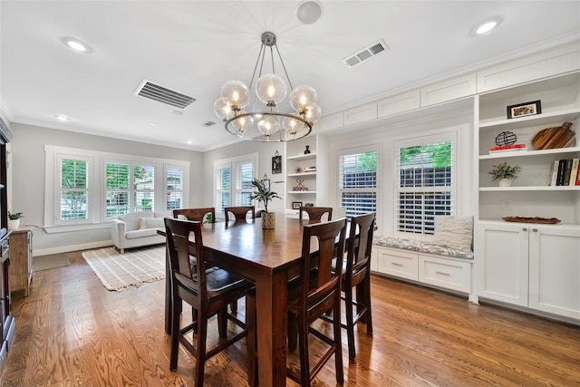 423 Pecore St, Houston, TX 77009 - dining room featuring ornamental molding, wood finished floors, a chandelier, recessed lighting, and built in features