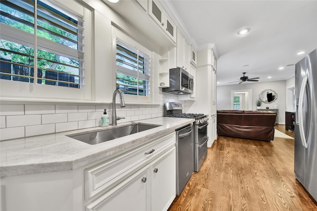 423 Pecore St, Houston, TX 77009 - kitchen with stainless steel appliances, healthy amount of natural light, white cabinetry, backsplash, and recessed lighting