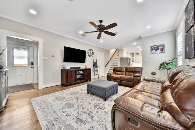 423 Pecore St, Houston, TX 77009 - living room with stairs, ceiling fan, recessed lighting, light wood-style flooring, and crown molding
