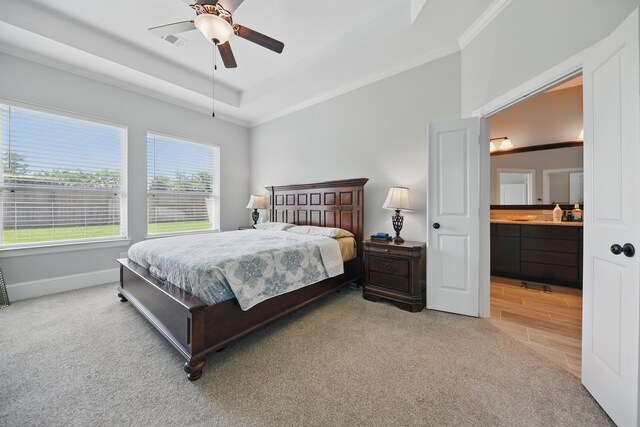 3601 Haskell Hollow Loop, College Station, TX 77845 - bedroom with crown molding, baseboards, a raised ceiling, connected bathroom, and light colored carpet