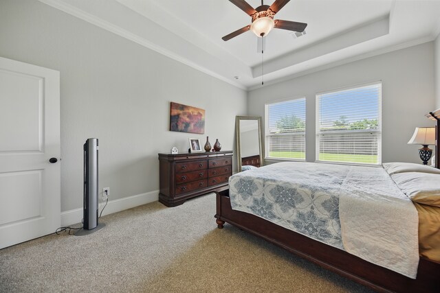 3601 Haskell Hollow Loop, College Station, TX 77845 - carpeted bedroom with a tray ceiling, baseboards, ceiling fan, and ornamental molding
