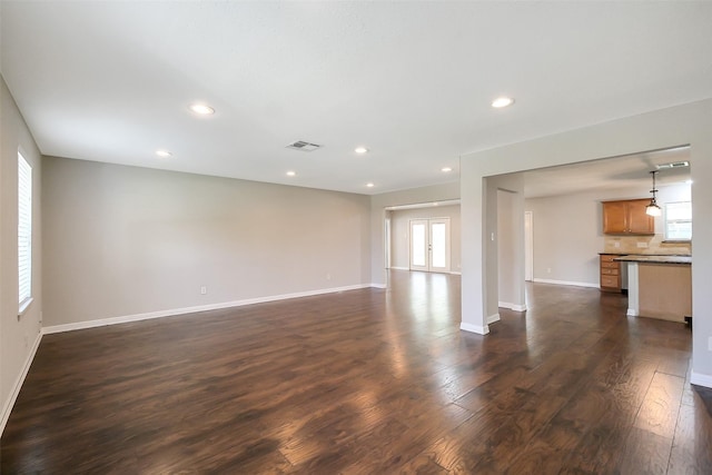 10422 Shadow Wood Dr, Houston, TX 77043 - unfurnished living room with dark wood finished floors, baseboards, and recessed lighting