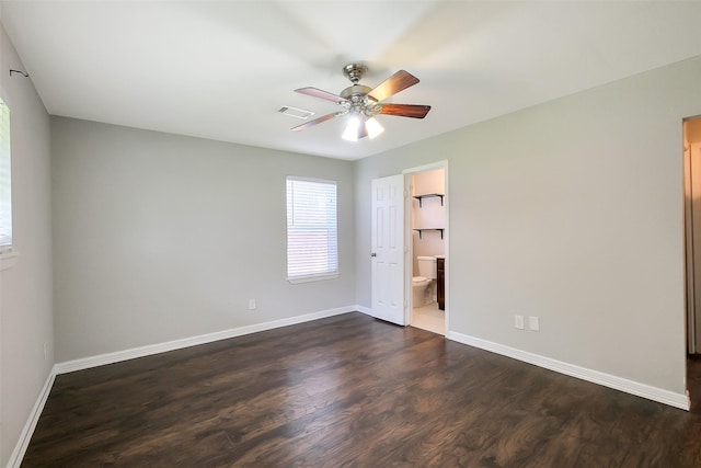 10422 Shadow Wood Dr, Houston, TX 77043 - unfurnished bedroom with dark wood-type flooring, baseboards, a ceiling fan, and ensuite bath