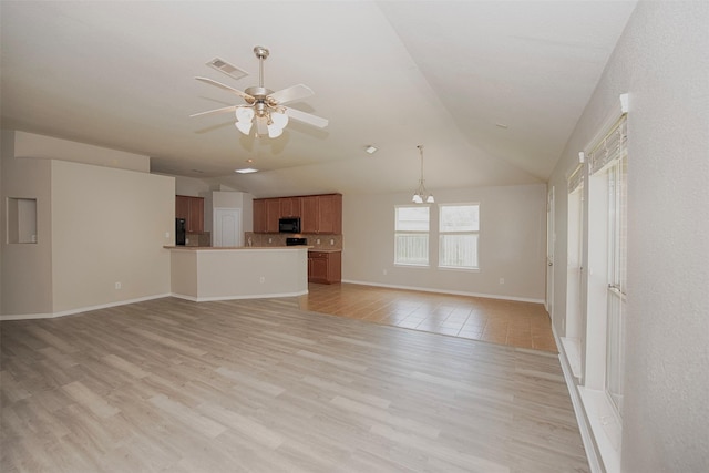 446 De Coster Blvd, Alvin, TX 77511 - unfurnished living room featuring ceiling fan, lofted ceiling, light wood-style floors, baseboards, and a chandelier