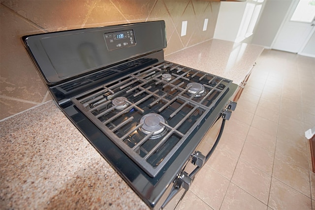 446 De Coster Blvd, Alvin, TX 77511 - kitchen view of gas stove, tasteful backsplash, and light stone counters