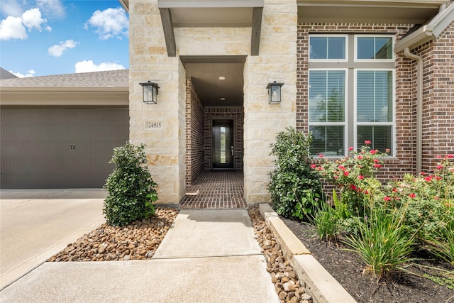 24815 Pavonia Lake Ln, Tomball, TX 77375 - doorway to property featuring driveway, an attached garage, stone siding, and brick siding