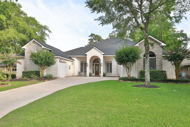 6611 Course View Ln, Spring, TX 77389 - view of front facade featuring stone siding, concrete driveway, a front lawn, stucco siding, and a shingled roof