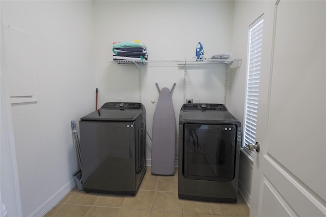 4023 Avenue S, Galveston, TX 77550 - washroom featuring independent washer and dryer, light tile patterned floors, and baseboards