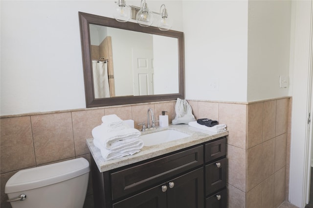 4023 Avenue S, Galveston, TX 77550 - full bathroom featuring tile walls, toilet, vanity, and a wainscoted wall