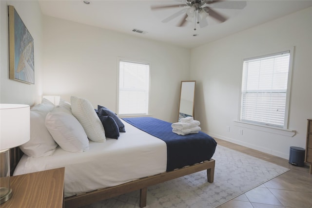 4023 Avenue S, Galveston, TX 77550 - bedroom with multiple windows, tile patterned floors, ceiling fan, and baseboards