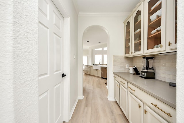 527 Little River Ct, Richmond, TX 77406 - corridor with ornamental molding, light wood finished floors, a sink, and arched walkways