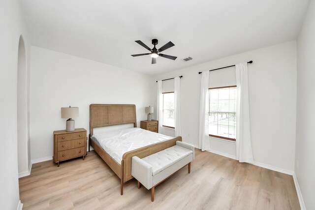 527 Little River Ct, Richmond, TX 77406 - bedroom featuring light wood finished floors, baseboards, and arched walkways