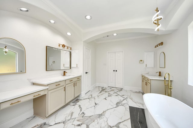 527 Little River Ct, Richmond, TX 77406 - bathroom featuring two vanities, recessed lighting, a freestanding bath, marble finish floors, and baseboards