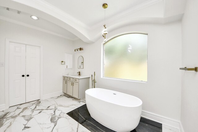 527 Little River Ct, Richmond, TX 77406 - bathroom featuring vanity, a freestanding tub, ornamental molding, marble look tiles, and baseboards