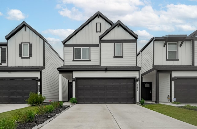 12319 Brandenburg Gate Dr, Houston, TX 77047 - view of front of home featuring board and batten siding, a garage, and driveway