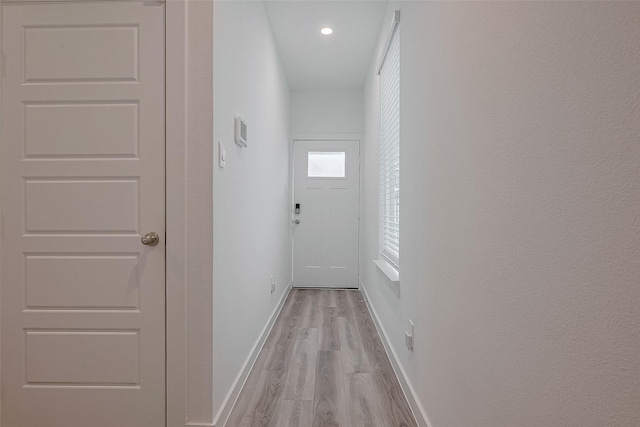 12319 Brandenburg Gate Dr, Houston, TX 77047 - doorway to outside featuring light wood finished floors, baseboards, and recessed lighting