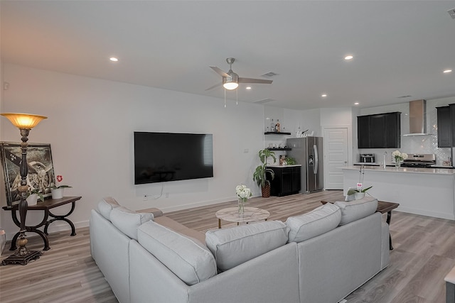 12319 Brandenburg Gate Dr, Houston, TX 77047 - living room featuring light wood finished floors, ceiling fan, recessed lighting, and baseboards