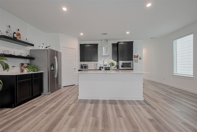 12319 Brandenburg Gate Dr, Houston, TX 77047 - kitchen with stainless steel appliances, wall chimney exhaust hood, dark cabinets, light countertops, and recessed lighting