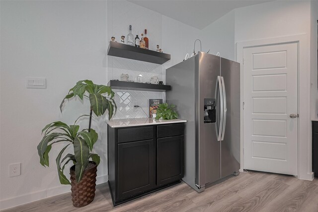12319 Brandenburg Gate Dr, Houston, TX 77047 - kitchen with stainless steel fridge, light wood finished floors, open shelves, and light countertops