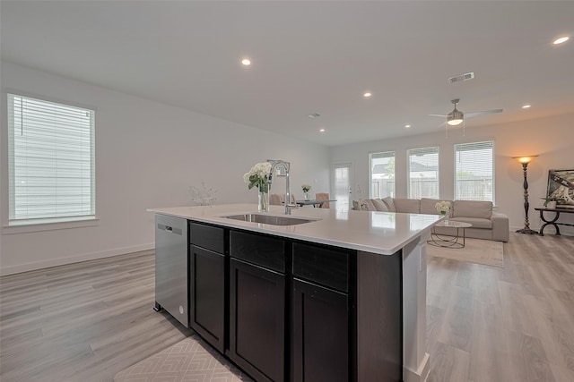 12319 Brandenburg Gate Dr, Houston, TX 77047 - kitchen featuring dishwasher, a sink, light countertops, light wood-style floors, and recessed lighting