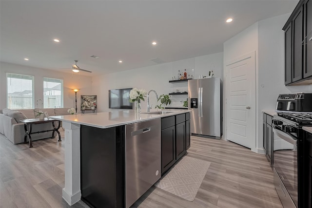 12319 Brandenburg Gate Dr, Houston, TX 77047 - kitchen featuring appliances with stainless steel finishes, a sink, open floor plan, light countertops, and recessed lighting