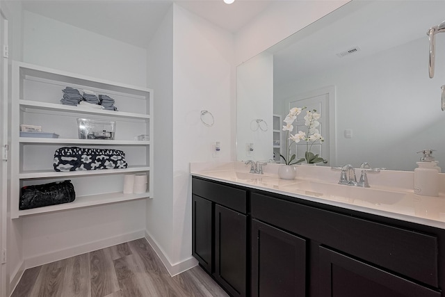 12319 Brandenburg Gate Dr, Houston, TX 77047 - full bath featuring double vanity, wood finished floors, and baseboards