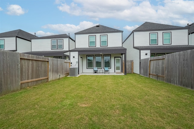 12319 Brandenburg Gate Dr, Houston, TX 77047 - rear view of house featuring a patio area, a shingled roof, and central AC