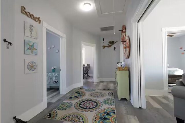 1514 18th St, Galveston, TX 77550 - hallway with attic access, wood finished floors, and baseboards