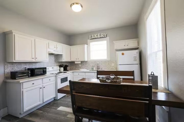1514 18th St, Galveston, TX 77550 - kitchen featuring white appliances, tasteful backsplash, white cabinets, and a sink