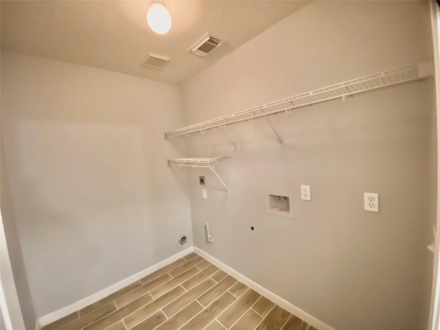 17419 Prospect Meadows Dr, Houston, TX 77095 - washroom featuring hookup for an electric dryer, washer hookup, baseboards, wood finished floors, and hookup for a gas dryer