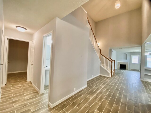 17419 Prospect Meadows Dr, Houston, TX 77095 - hall featuring baseboards, wood finished floors, and stairway