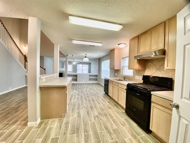 17419 Prospect Meadows Dr, Houston, TX 77095 - kitchen with black appliances, under cabinet range hood, light brown cabinetry, light wood-type flooring, and light countertops