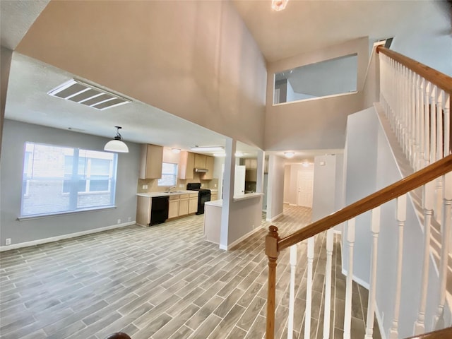 17419 Prospect Meadows Dr, Houston, TX 77095 - stairway featuring baseboards, wood finished floors, and a high ceiling