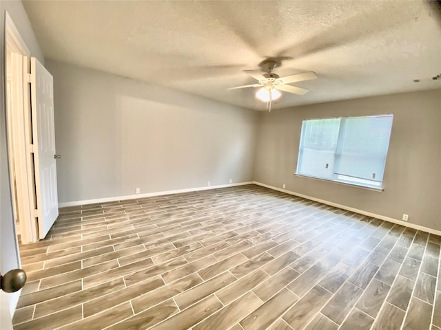 17419 Prospect Meadows Dr, Houston, TX 77095 - unfurnished room with a ceiling fan, baseboards, wood finished floors, and a textured ceiling