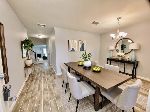 17419 Prospect Meadows Dr, Houston, TX 77095 - dining space with wood tiled floors, baseboards, and a chandelier